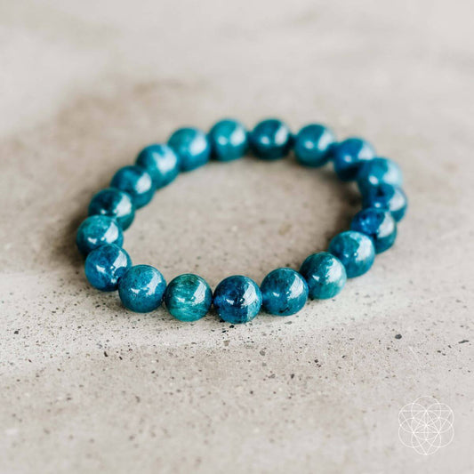 Teal blue beaded bracelet with round gemstone-style beads