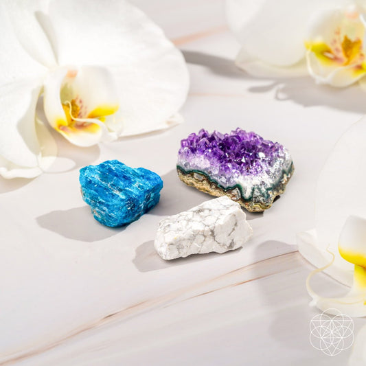 Trio of raw crystals: blue, purple, and white marbled stones arranged together