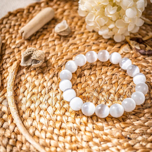 White beaded cleansing bracelet with round stones in a circular design