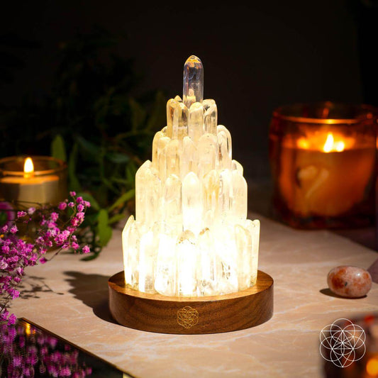Clear quartz tower lamp with lit crystal cluster and round wooden base