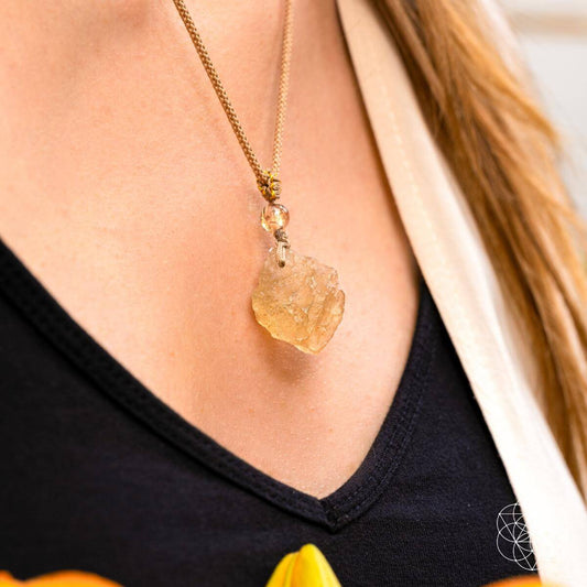 Gold-tone necklace with raw amber desert-glass teardrop pendant