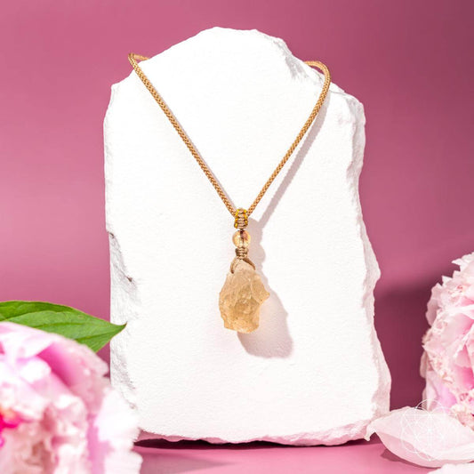 Gold-tone chain with raw amber desert-glass teardrop pendant