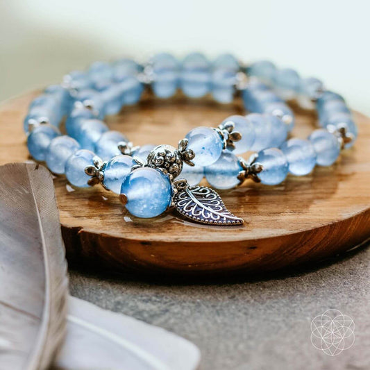 Blue chalcedony bead bracelet with gold-toned accents and leaf charm