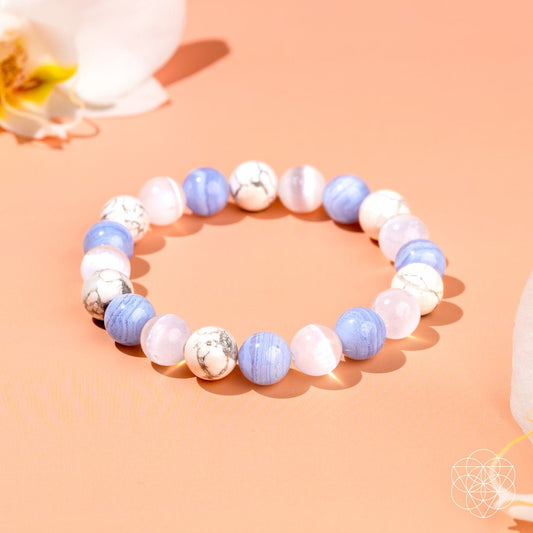 Blue and white beaded bracelet with silver-look centerpiece beads, elastic stretch fit