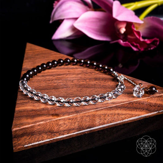 Energy Shield anklet with dark beaded strands and silver-tone charm detail