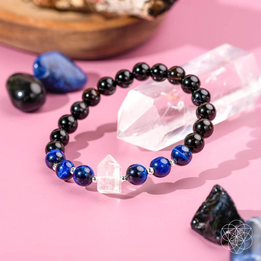 Beaded bracelet with dark beads, blue tiger’s-eye beads, and clear quartz accent