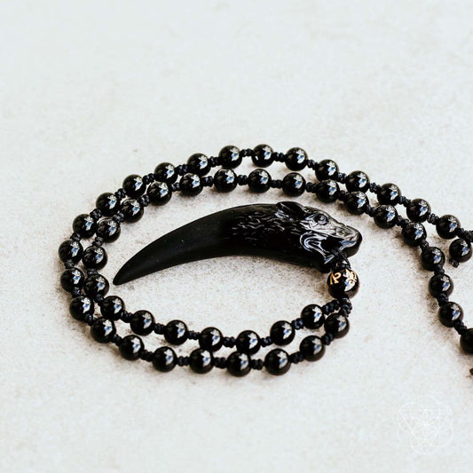 Black beaded necklace with wolf tooth pendant