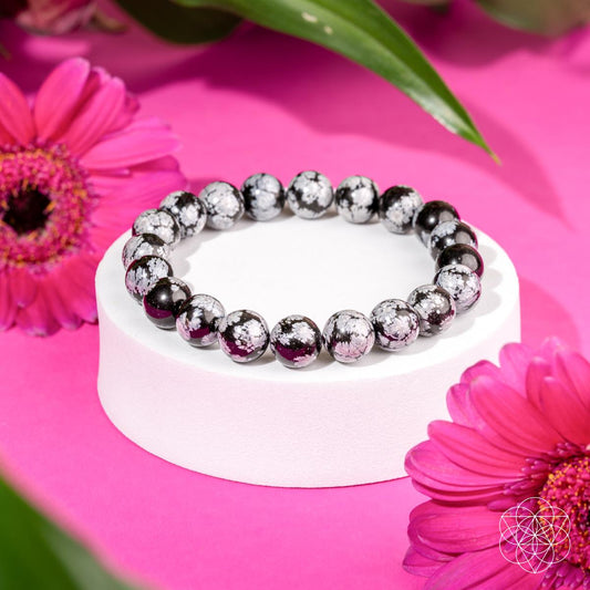 Snowflake obsidian bead bracelet with black and white speckled round stones.