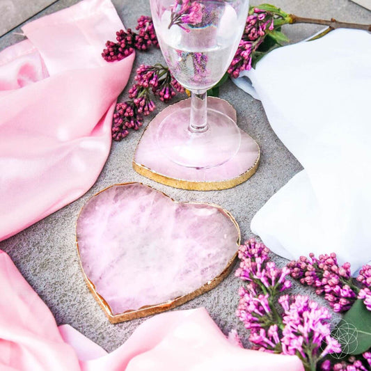 Heart-shaped rose quartz coaster with pink veining and gold-toned edge border