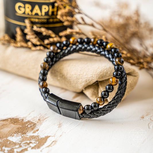 Black bead bracelet with gold accent beads and a dark metal clasp