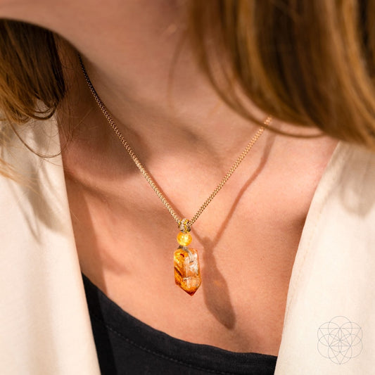 Amber citrine pendant on gold chain worn at the neckline