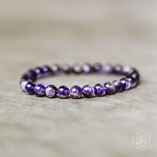 Purple beaded purification bracelet with round gemstone-like beads