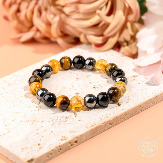 Beaded protection bracelet with black and amber/gold stones in a stretch design.