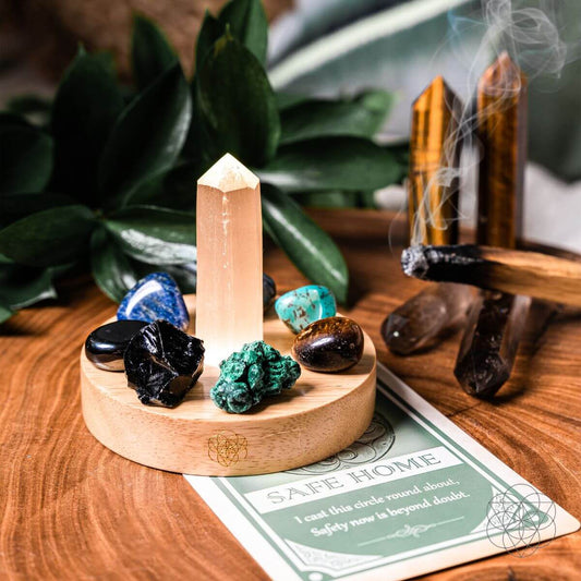 Rose quartz crystal point on round wooden base with tumbled stones and incense smoke
