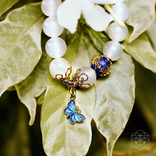 White agate bead bracelet with gold butterfly charm and blue accents