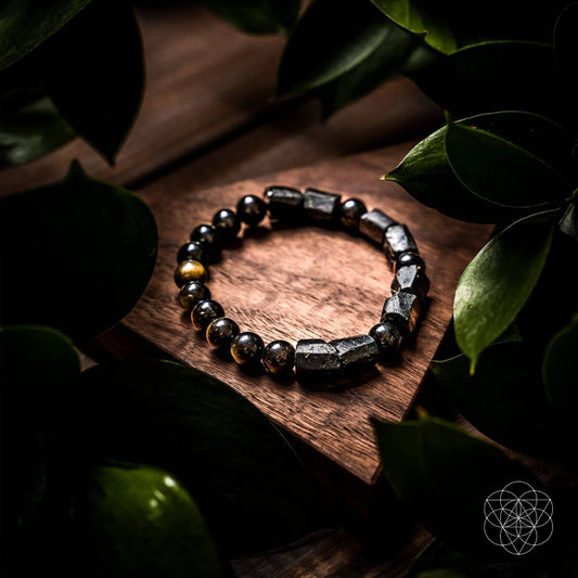 Black beaded protection bracelet with black stone segments and gold accent beads