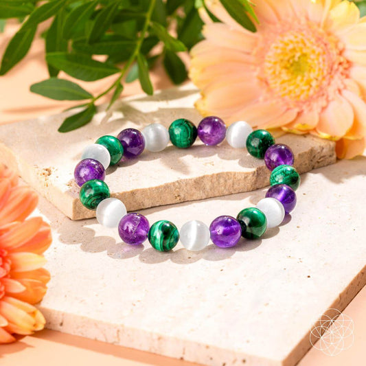 Multicolor beaded healing bracelet with green, purple, and white round stones on elastic