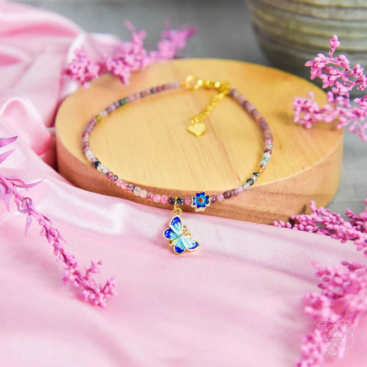 Beaded anklet with multicolor stones and a blue flower charm