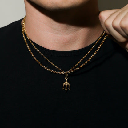 Gold rope-chain necklace with small trident pendant drop