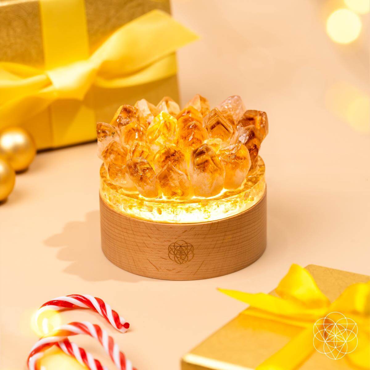 Glowing citrine crystal lamp on a light wood base