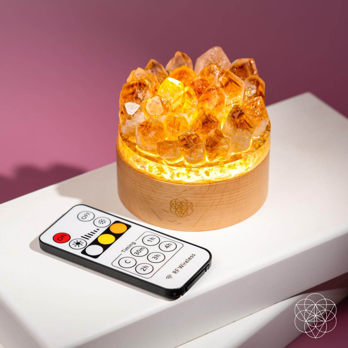Citrine crystal lamp with included remote control on a white surface