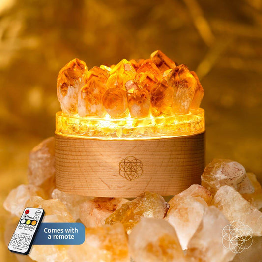 Citrine crystal lamp with glowing crystal cluster on a light wood round base