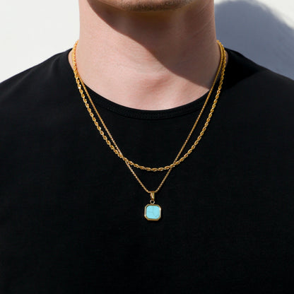 Gold-tone necklace with turquoise square pendant, layered chain look