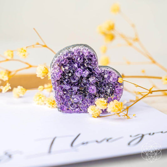 Purple amethyst heart-shaped cluster stone, sparkle-filled geode texture.