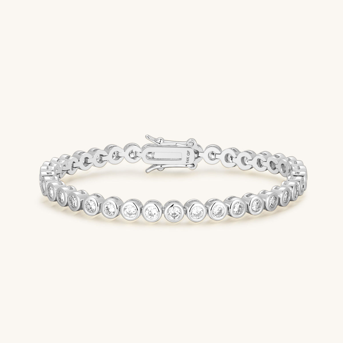 Silver tone diamond tennis bracelet with round bezel links and spring clasp