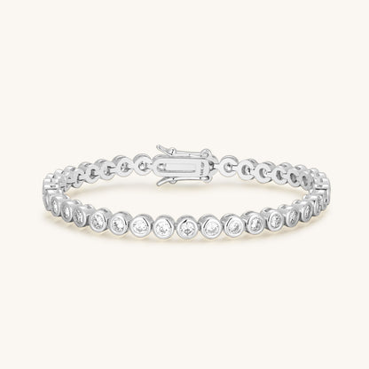 Silver tone diamond tennis bracelet with round bezel links and spring clasp