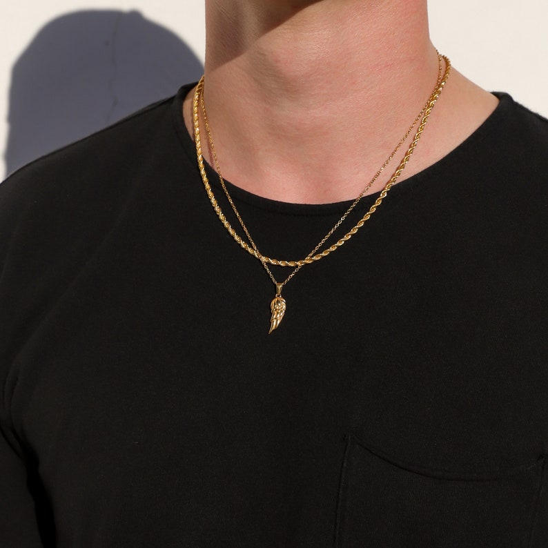Gold angel wing pendant necklace set on layered rope chains