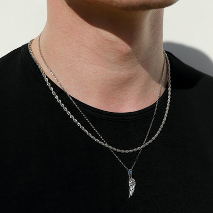 Close-up of silver angel wing pendant on twist rope chain