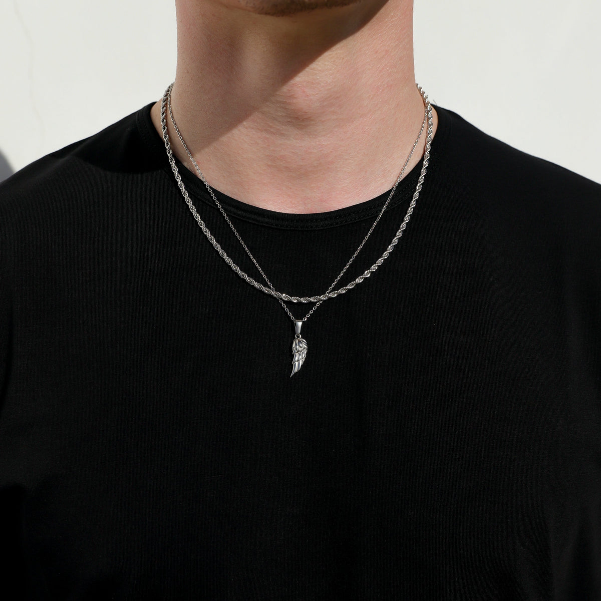 Silver angel wing pendant necklace set on layered rope chains