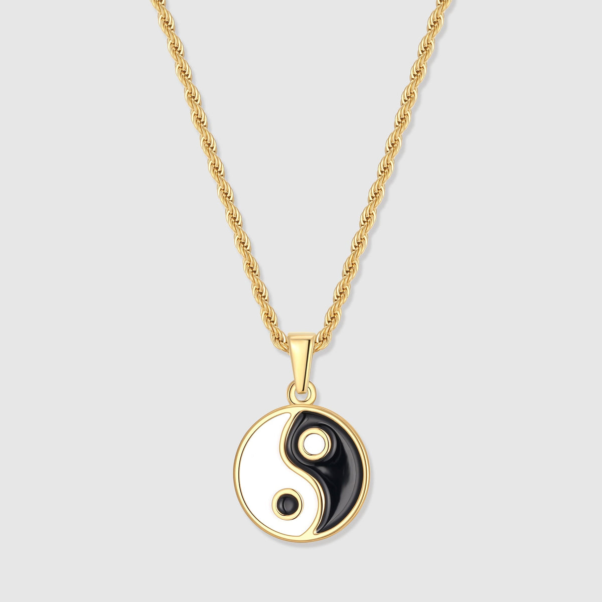 Gold yin yang pendant with black and white enamel yin-yang on a short bail