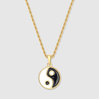 Gold yin yang pendant with black and white enamel yin-yang on a short bail