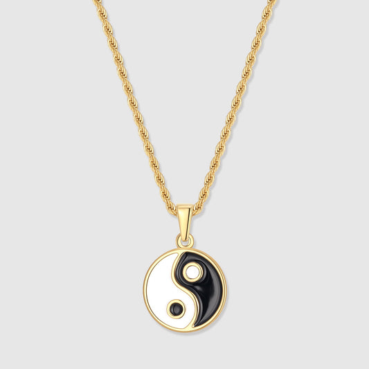 Gold yin yang pendant with black and white enamel yin-yang on a short bail
